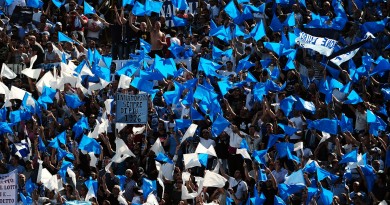 SSC Napoli's supporters cheer their team during their Serie A football match against FC Bologna at Dall'Ara stadium in Bologna on April 10, 2011.  AFP PHOTO / TIZIANA FABI (Photo credit should read TIZIANA FABI/AFP/Getty Images)