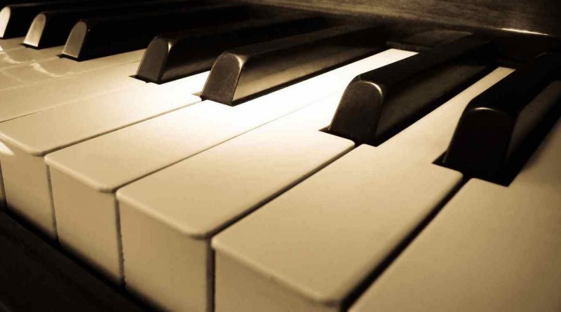 Close up shot of piano keyboard with spot light on