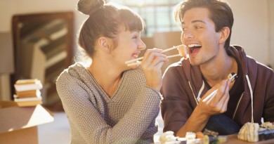 Couple eating sushi together in new home