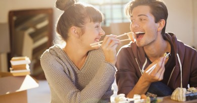 Couple eating sushi together in new home